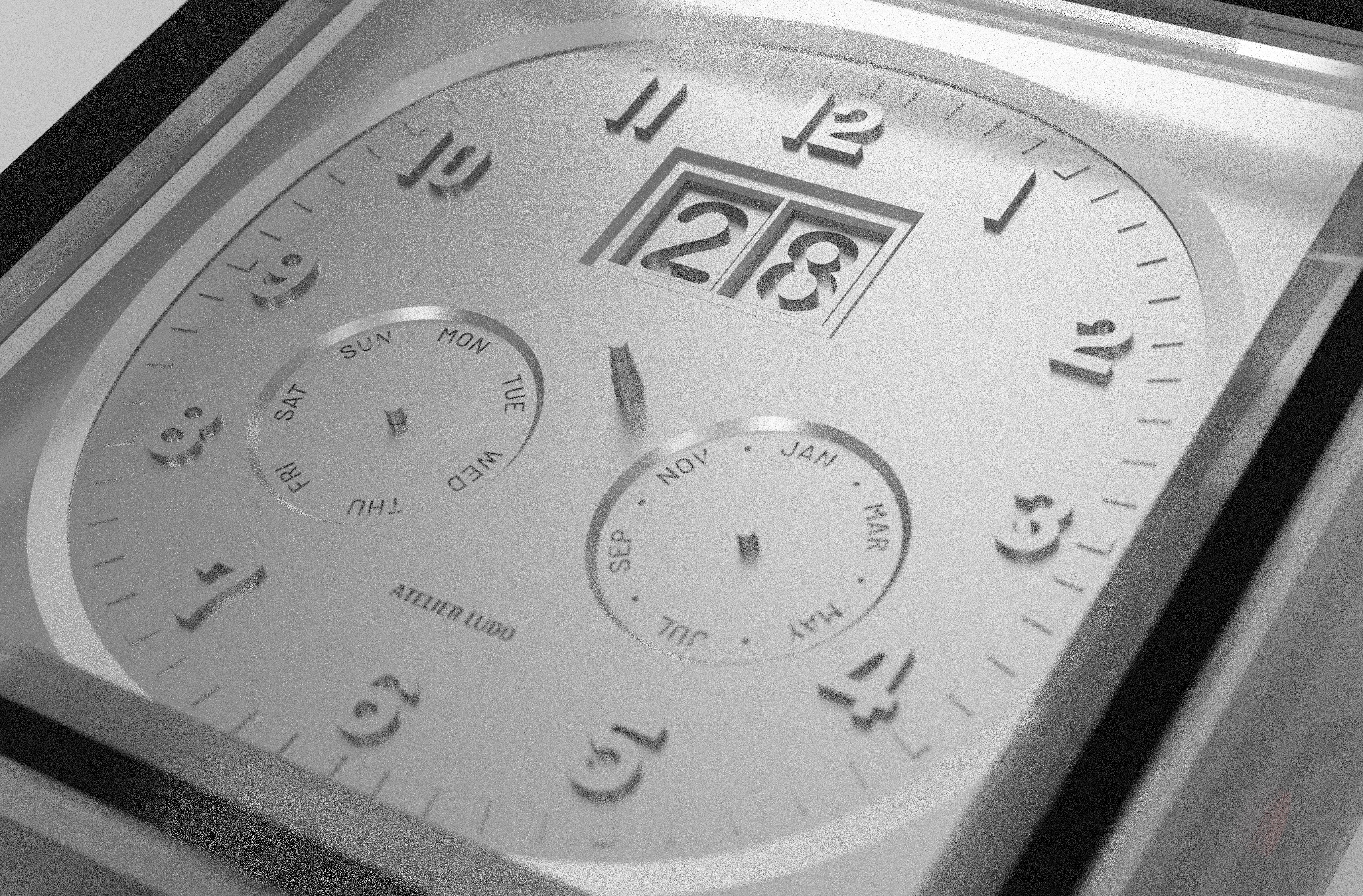 Tri-Date dial showing triangular date layout with large date window at top and weekday/month subdials